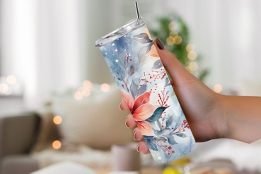 Thermobecher mit einem kunstvollen Weihnachtsstern-Design in Rot- und Blautönen, gehalten in einer Hand vor einem gemütlich beleuchteten Innenraum mit unscharfen, warmen Lichtakzenten im Hintergrund.